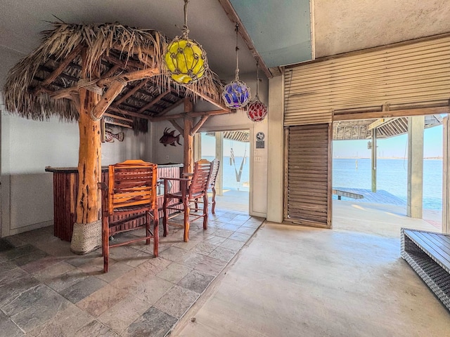 dining area featuring a water view and a healthy amount of sunlight