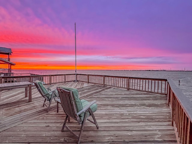 view of dock with a deck with water view