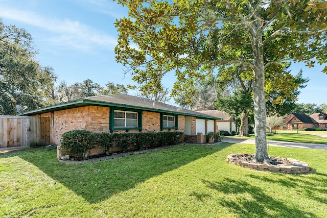 ranch-style house featuring a front yard and a garage