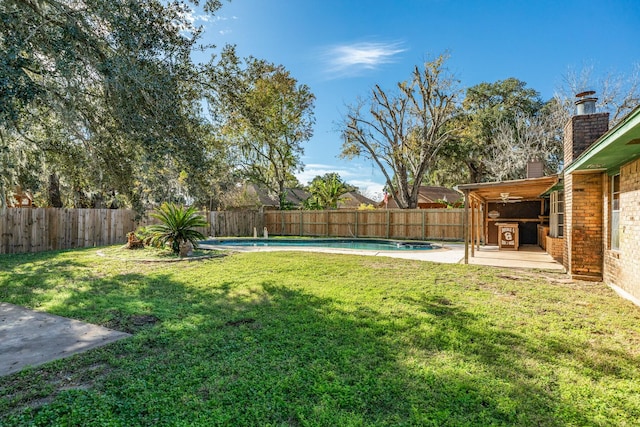 view of yard with a patio and a fenced in pool