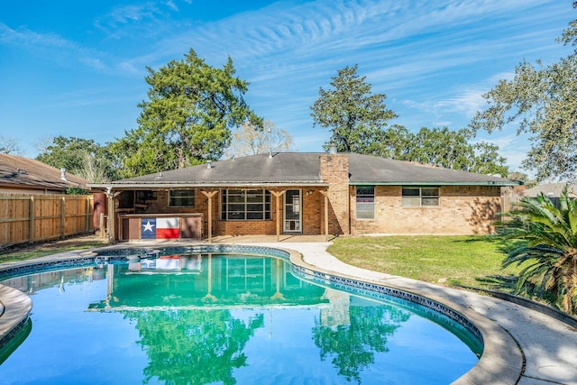 view of swimming pool featuring a yard and a patio