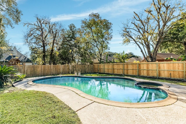 view of swimming pool featuring an in ground hot tub