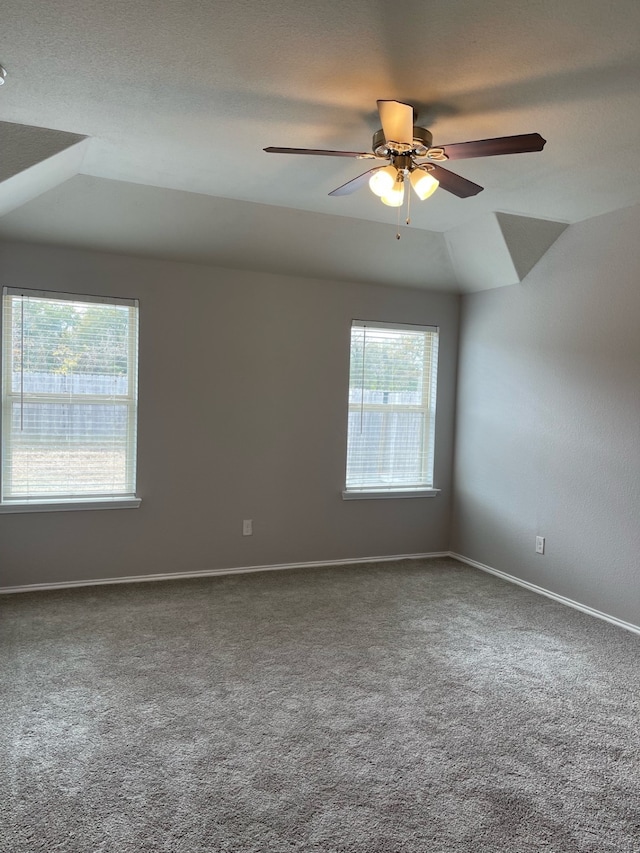 unfurnished room with vaulted ceiling, carpet, and ceiling fan