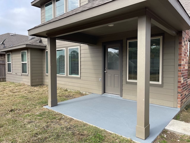 doorway to property featuring a yard and a patio area