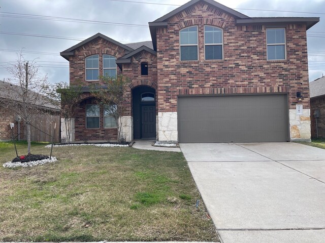 front of property featuring a garage and a front yard