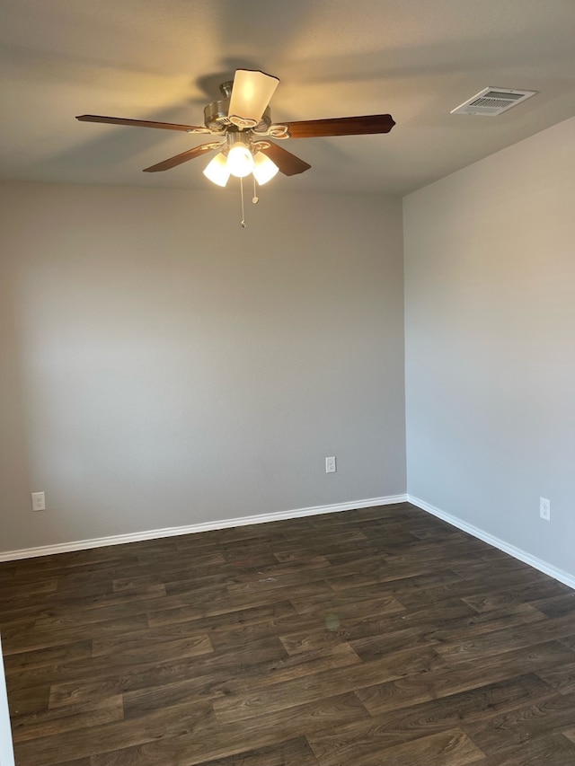 spare room with ceiling fan and dark wood-type flooring