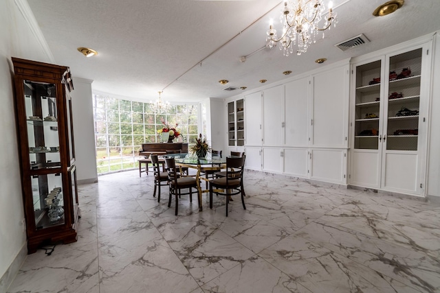 dining room featuring a textured ceiling, an inviting chandelier, and a wall of windows