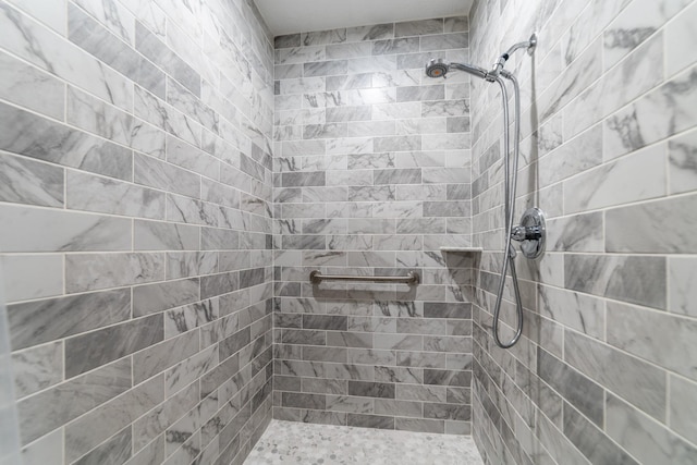 bathroom with a tile shower