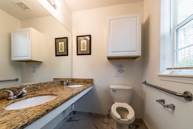 bathroom featuring toilet and sink