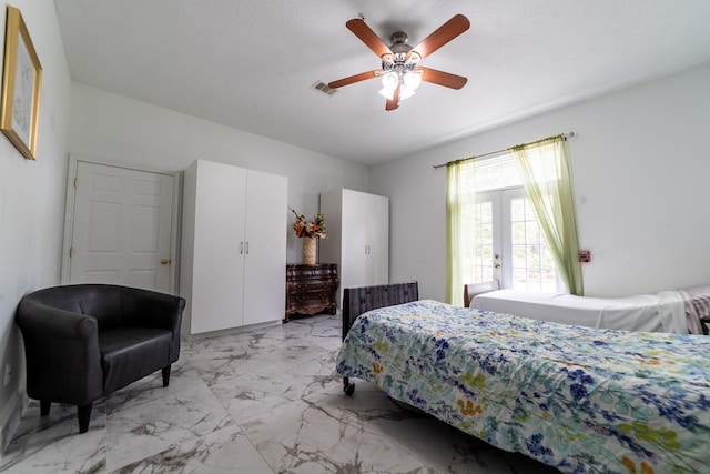 bedroom with ceiling fan and french doors