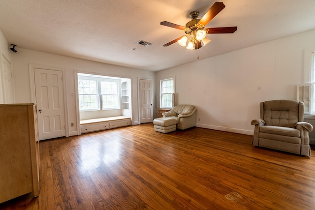 unfurnished room featuring a textured ceiling, ceiling fan, and hardwood / wood-style flooring