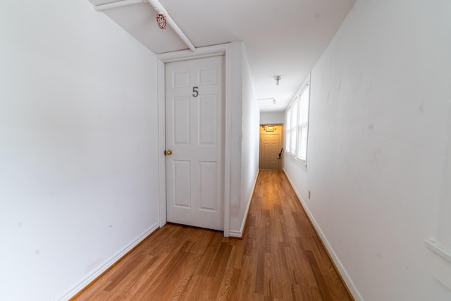 hall with light hardwood / wood-style flooring