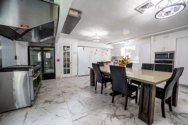 dining area featuring a textured ceiling