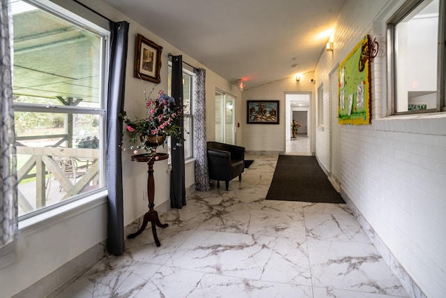 hallway with lofted ceiling