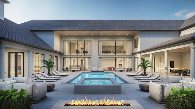 view of pool with an outdoor living space with a fire pit, an in ground hot tub, and a patio