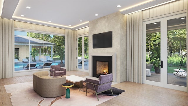 interior space with french doors, a fireplace, and light hardwood / wood-style flooring