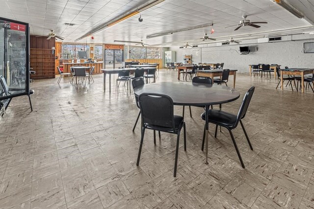 tiled dining space featuring ceiling fan