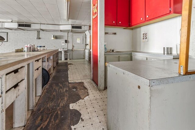 kitchen featuring sink, decorative backsplash, and light tile patterned floors