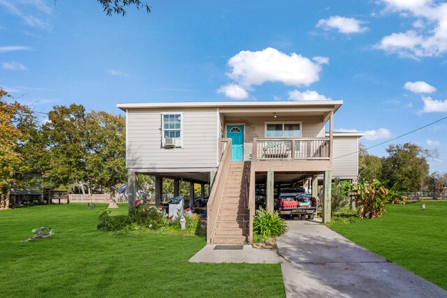 back of house featuring a yard and a carport