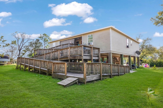 rear view of house with a deck and a lawn