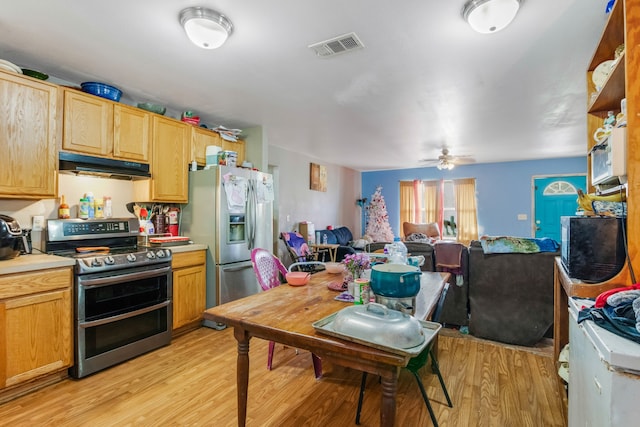 kitchen featuring appliances with stainless steel finishes, light brown cabinets, ceiling fan, and light hardwood / wood-style floors