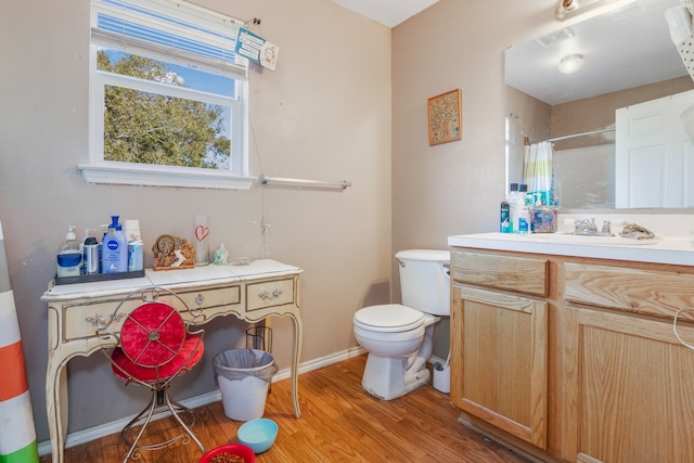 bathroom with vanity, toilet, hardwood / wood-style flooring, and curtained shower