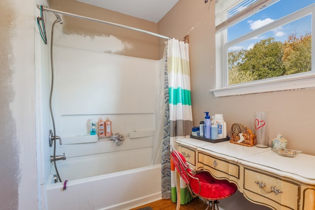 bathroom featuring wood-type flooring and shower / bath combo with shower curtain