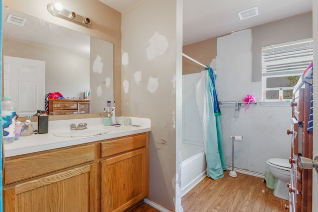 full bathroom with shower / bath combination with curtain, vanity, toilet, and hardwood / wood-style flooring