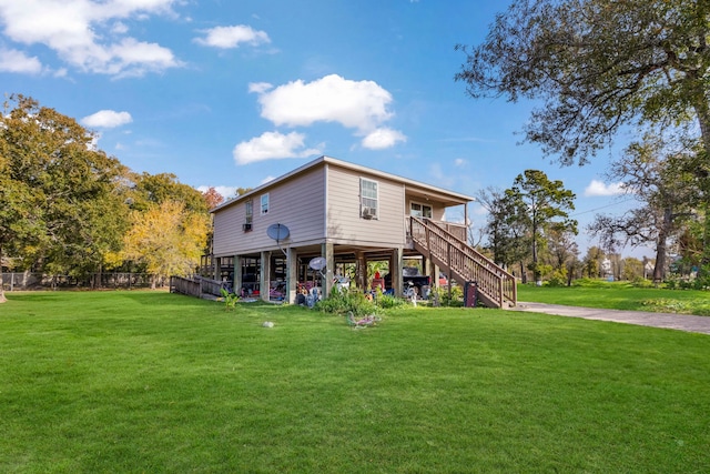 rear view of house featuring a lawn