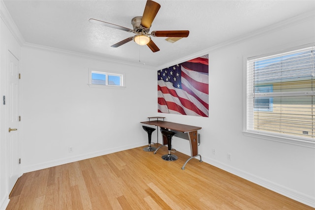 interior space featuring hardwood / wood-style floors, crown molding, and ceiling fan