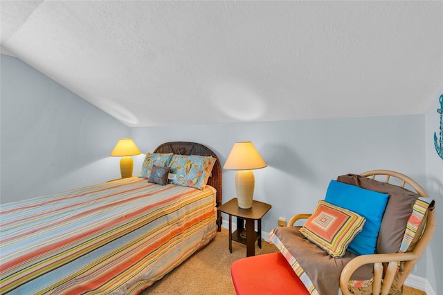 bedroom featuring carpet flooring, vaulted ceiling, and a textured ceiling