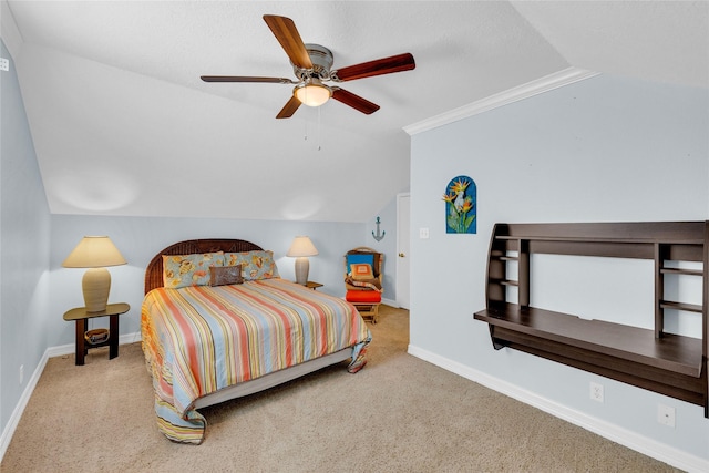 carpeted bedroom with ceiling fan, ornamental molding, and vaulted ceiling