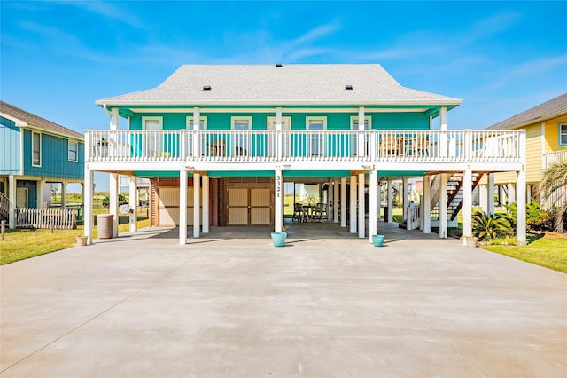 back of house featuring a carport and a deck