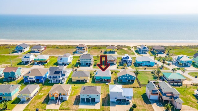 drone / aerial view featuring a water view and a beach view