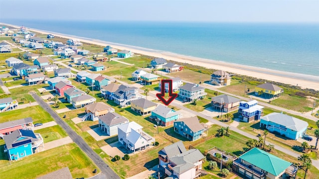 birds eye view of property with a view of the beach and a water view