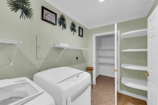 laundry room featuring ornamental molding, washer and clothes dryer, and light tile patterned floors