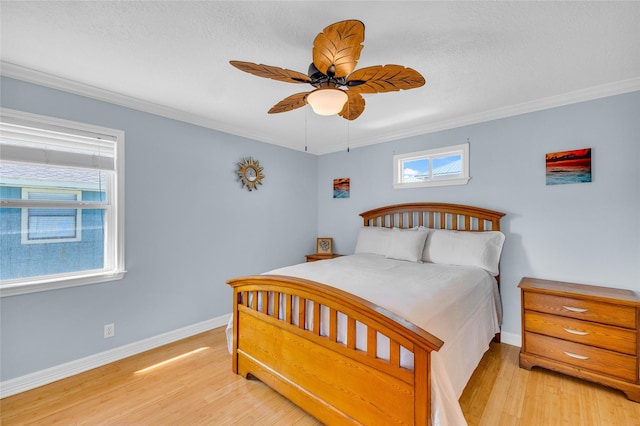 bedroom with crown molding, ceiling fan, and light hardwood / wood-style flooring