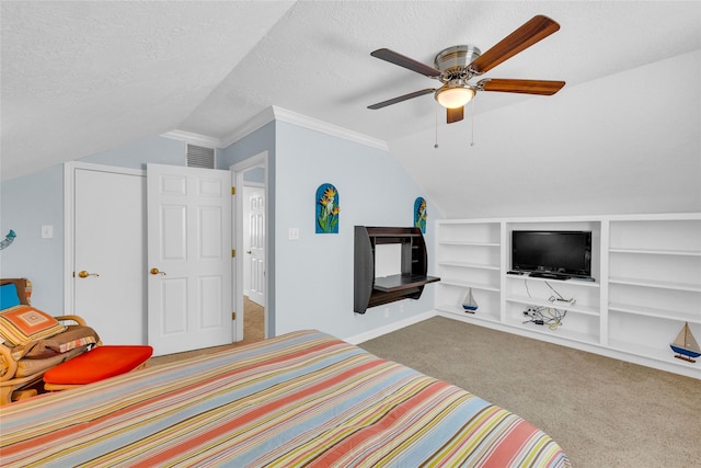 bedroom with vaulted ceiling, carpet floors, ceiling fan, crown molding, and a textured ceiling