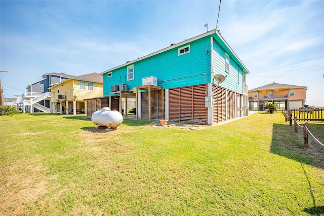 rear view of property featuring a lawn