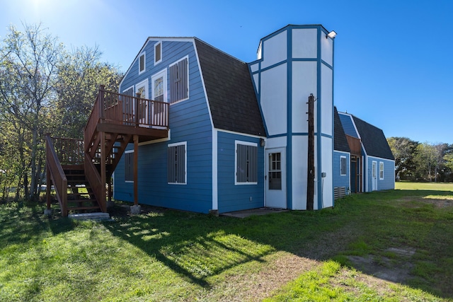 view of side of property with a deck and a yard