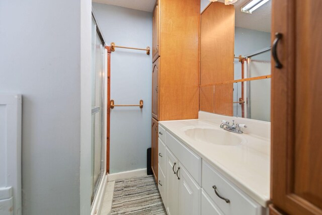 bathroom with walk in shower and vanity