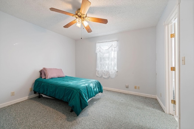 carpeted bedroom with a textured ceiling and ceiling fan