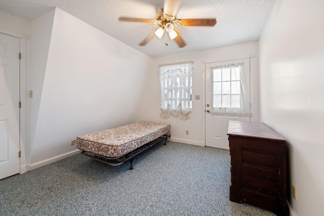 carpeted bedroom with a textured ceiling and ceiling fan