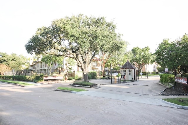 view of street with curbs, sidewalks, and a residential view