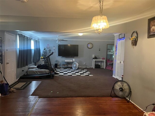 living room with ceiling fan with notable chandelier and dark hardwood / wood-style floors