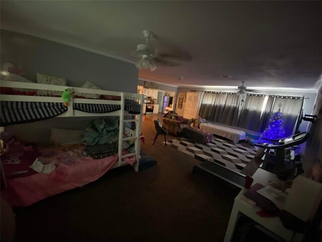 bedroom with ornamental molding and ceiling fan