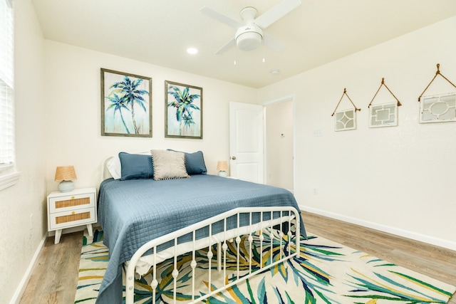 bedroom with hardwood / wood-style flooring and ceiling fan