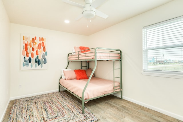 bedroom with wood-type flooring and ceiling fan