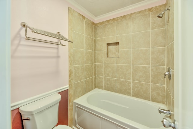 bathroom with tiled shower / bath, crown molding, and toilet