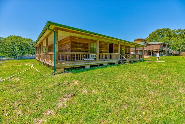 back of property featuring a lawn